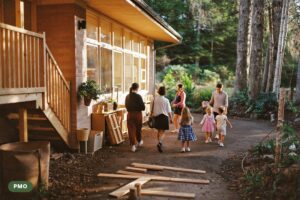 Families with young children arriving at a welcoming Canadian child care centre on a crisp morning